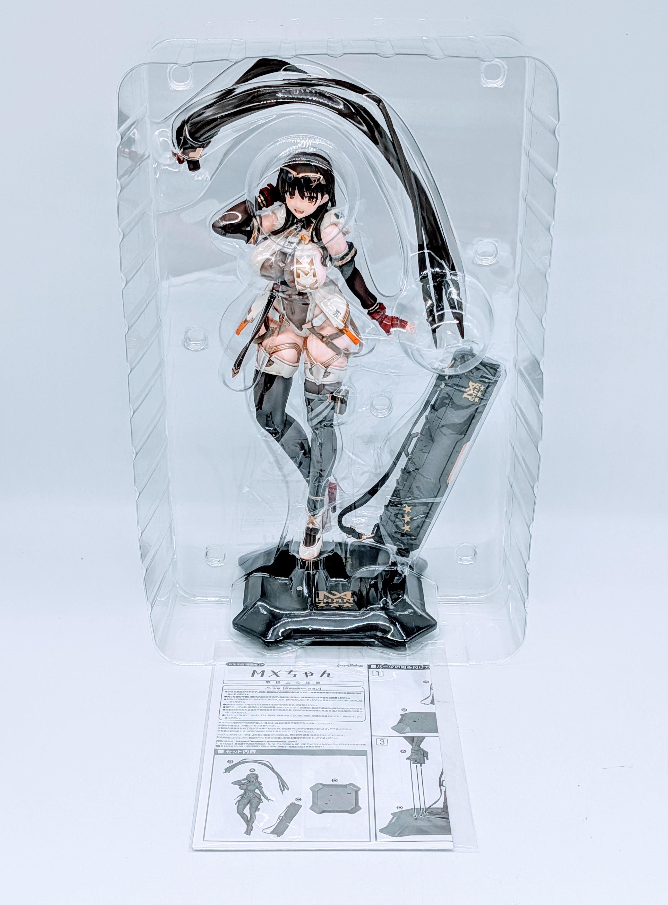 MX-chan figure body, accessories and base inside the blister tray