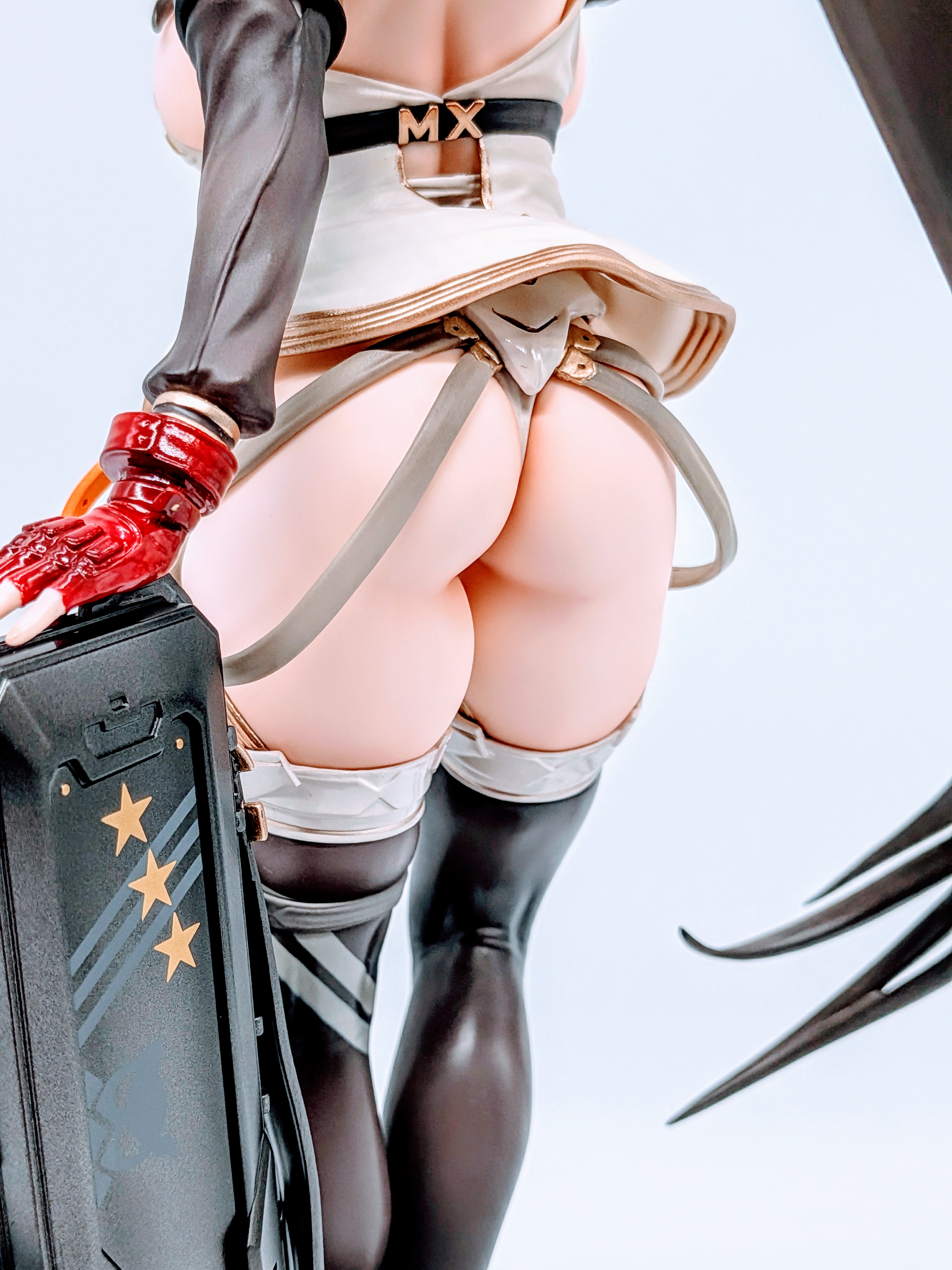 Low rear angle of MX-chan figure emphasizing hip line and tight outfit