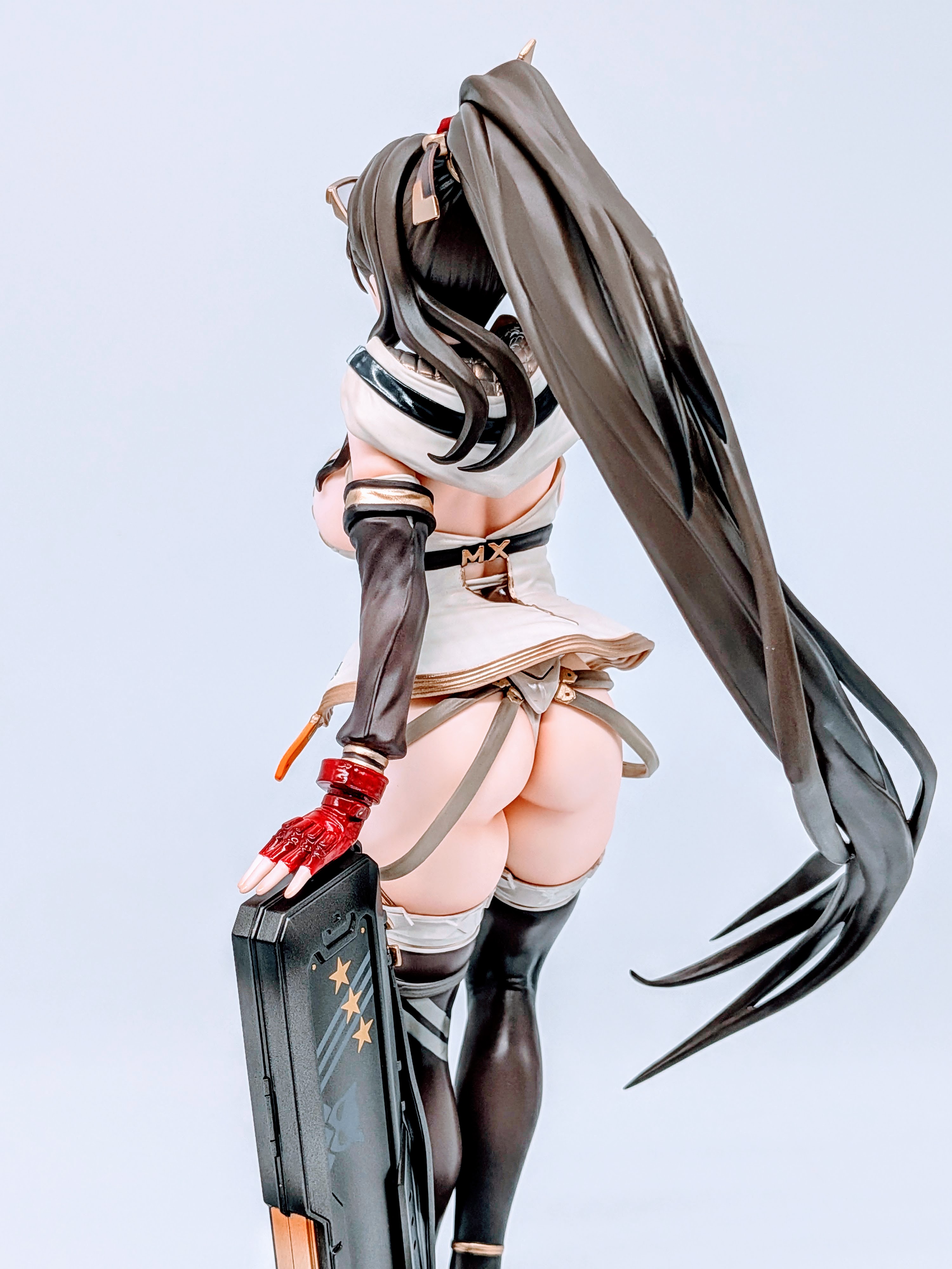 Back angle of MX-chan figure with legs, stockings and base visible