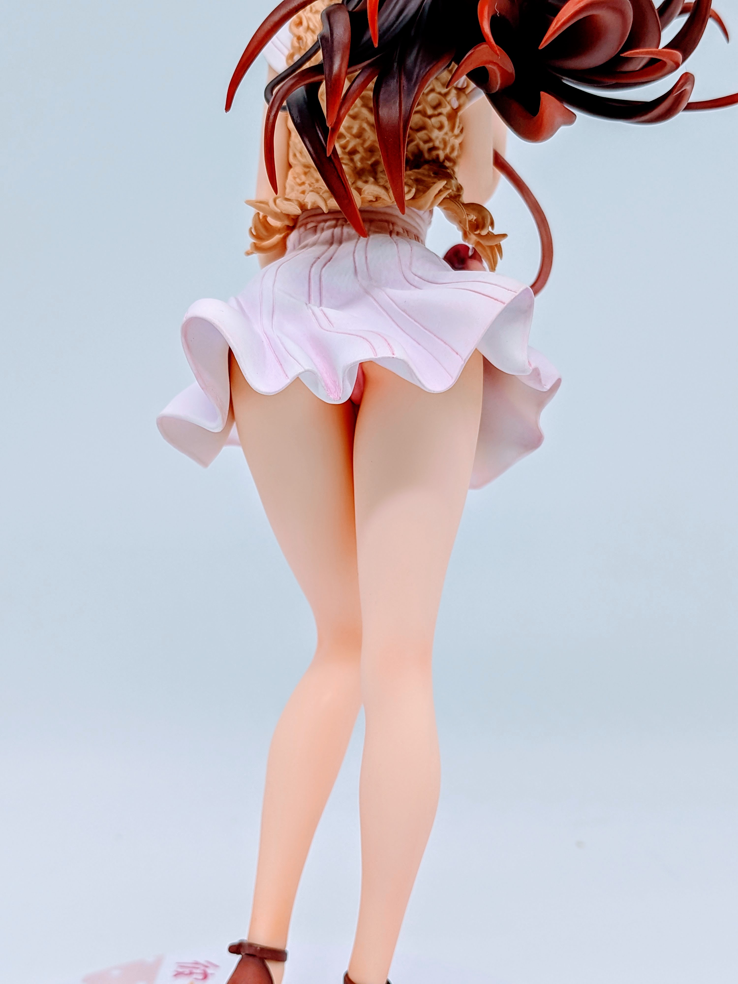Low back angle of Chizuru Mizuhara figure showing lifted skirt movement