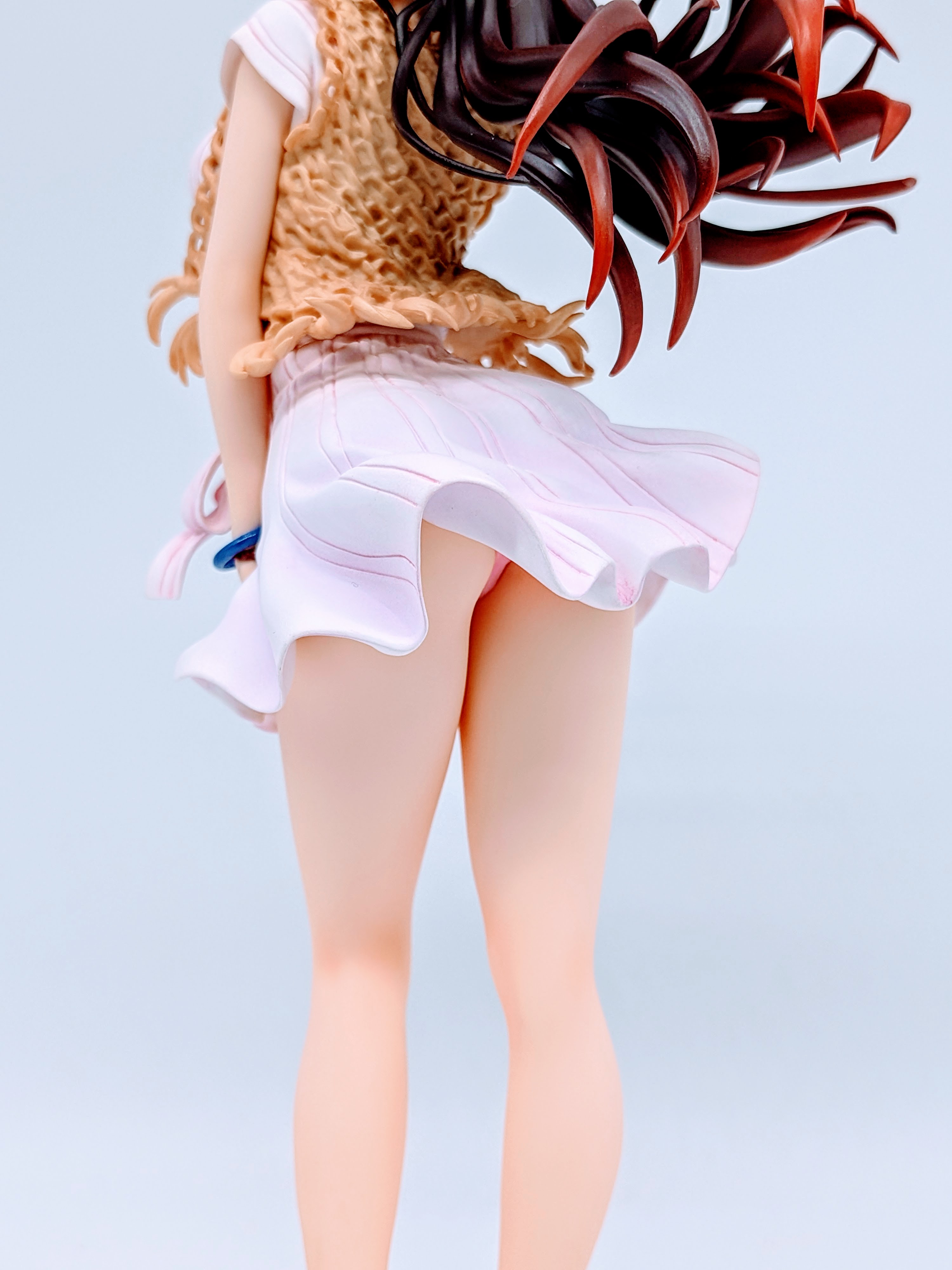 Back angle of Chizuru Mizuhara showing dress folds, hips and base