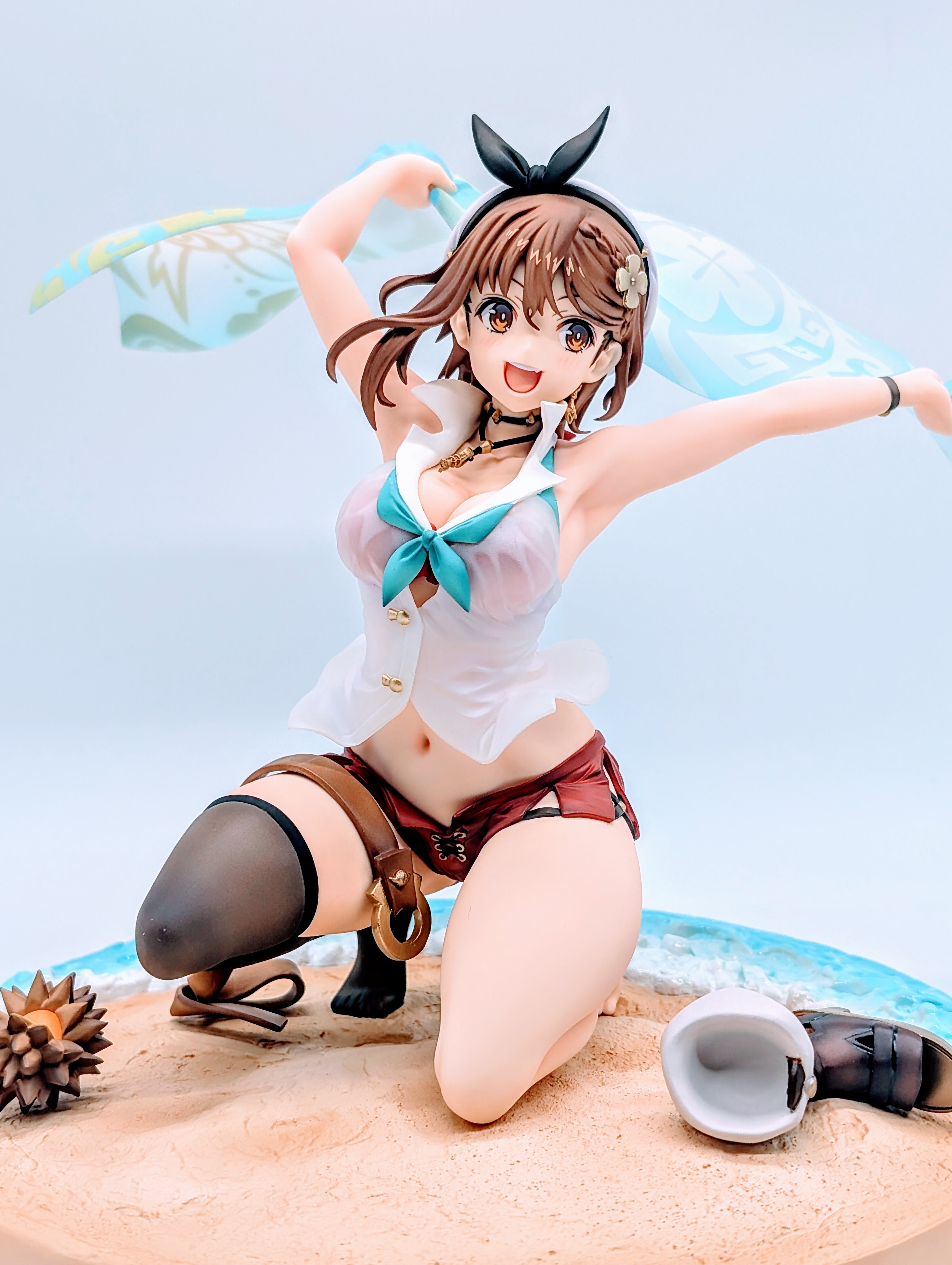 Close-up of Ryza’s smiling face with towel raised behind her