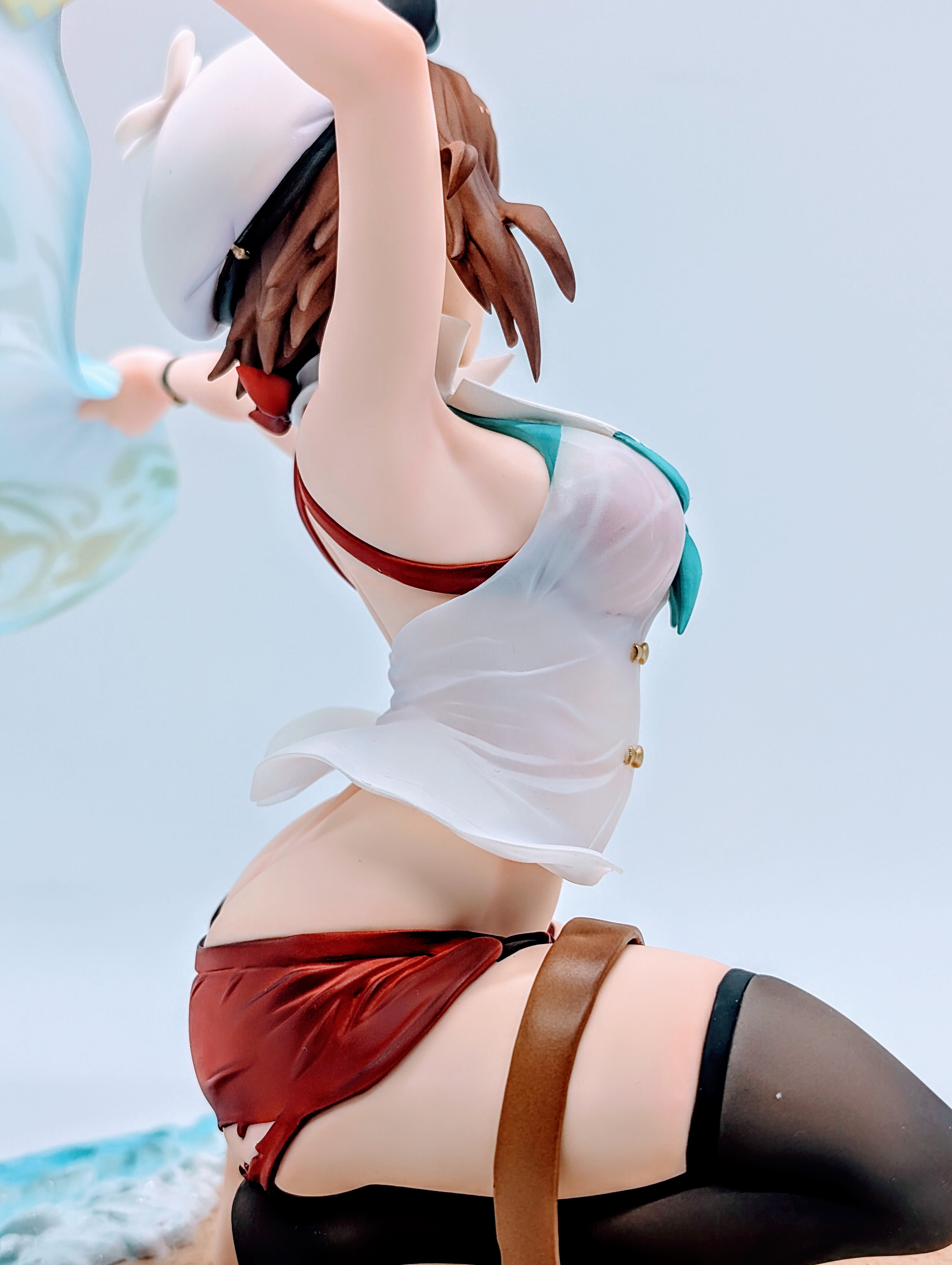 Side close-up of Ryza legs, stocking and bare foot on sand