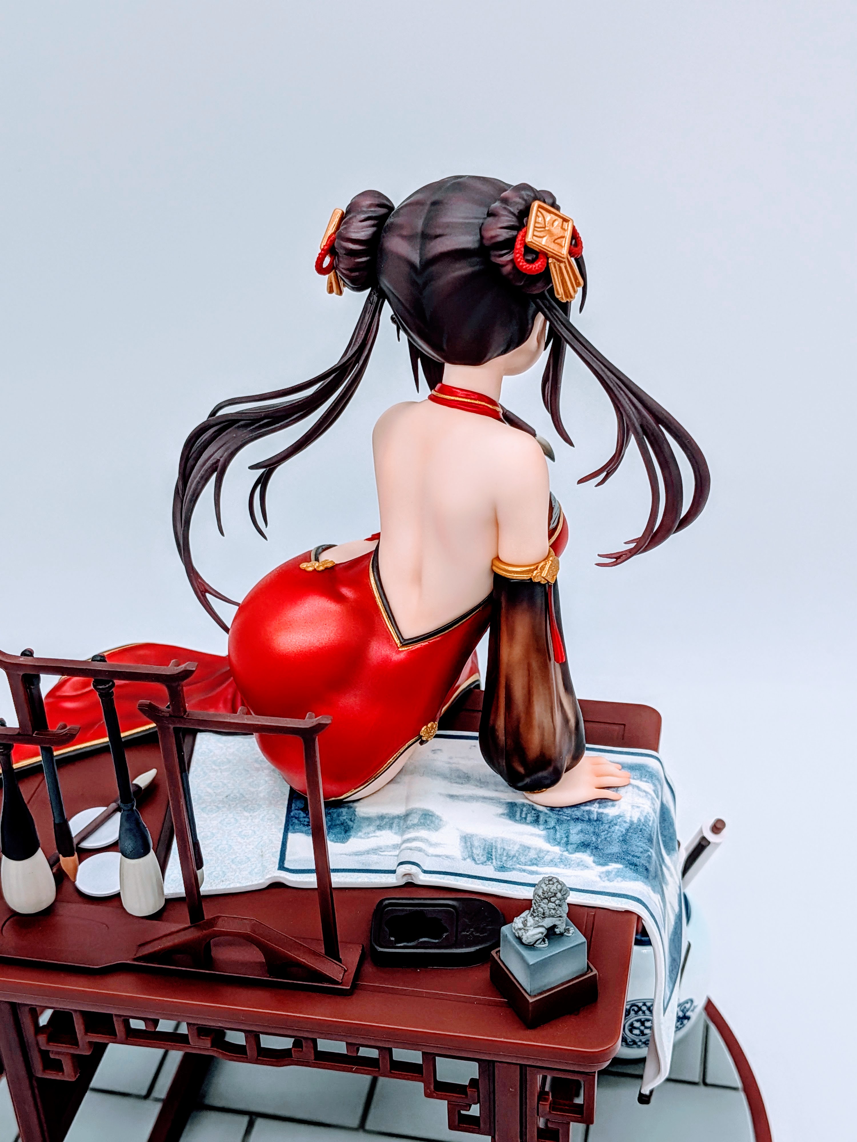 Rear close-up of Kurumi Tokisaki hips pressing against the dress while seated
