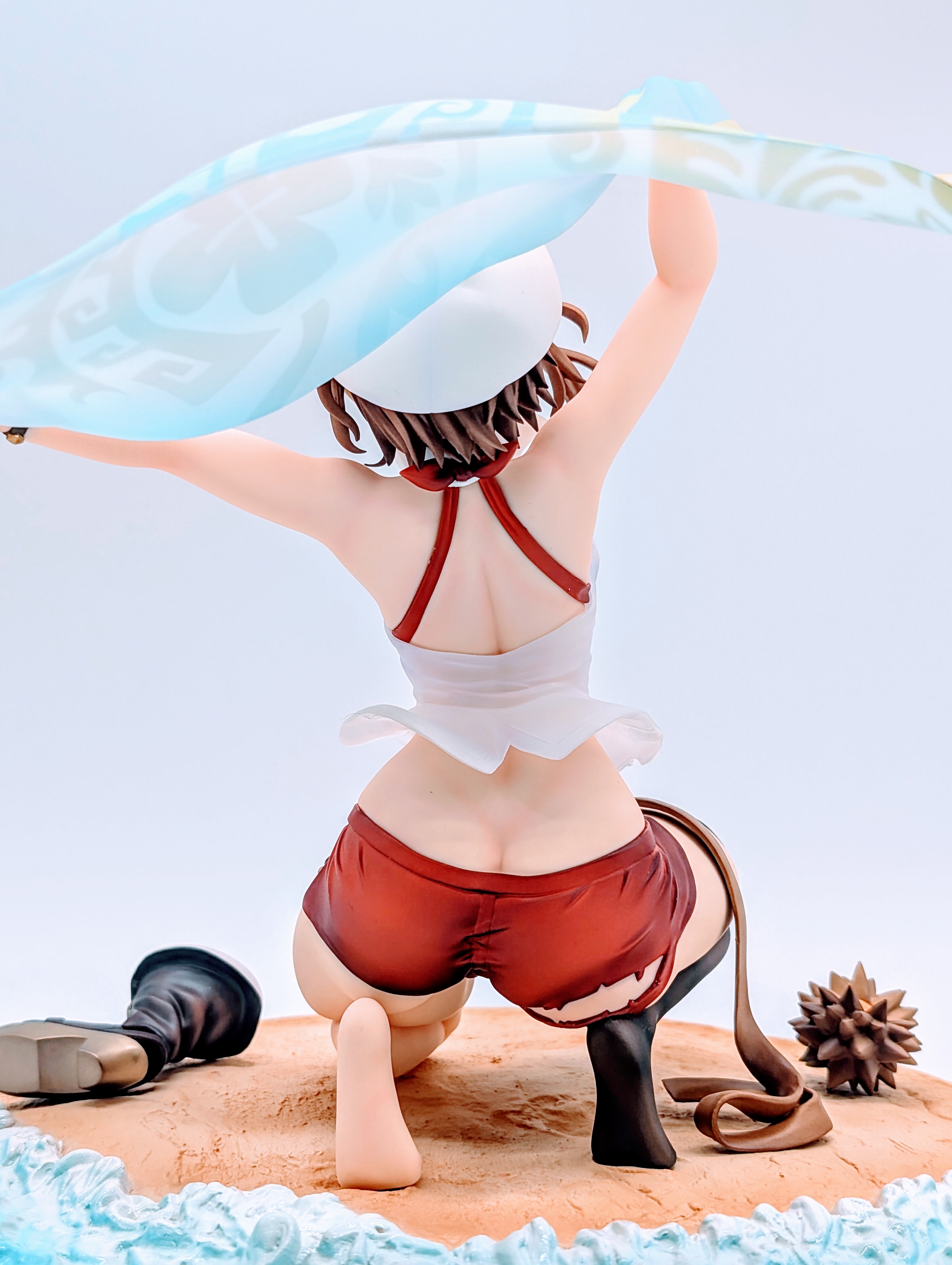 Full back view of Ryza beach figure with towel spread out