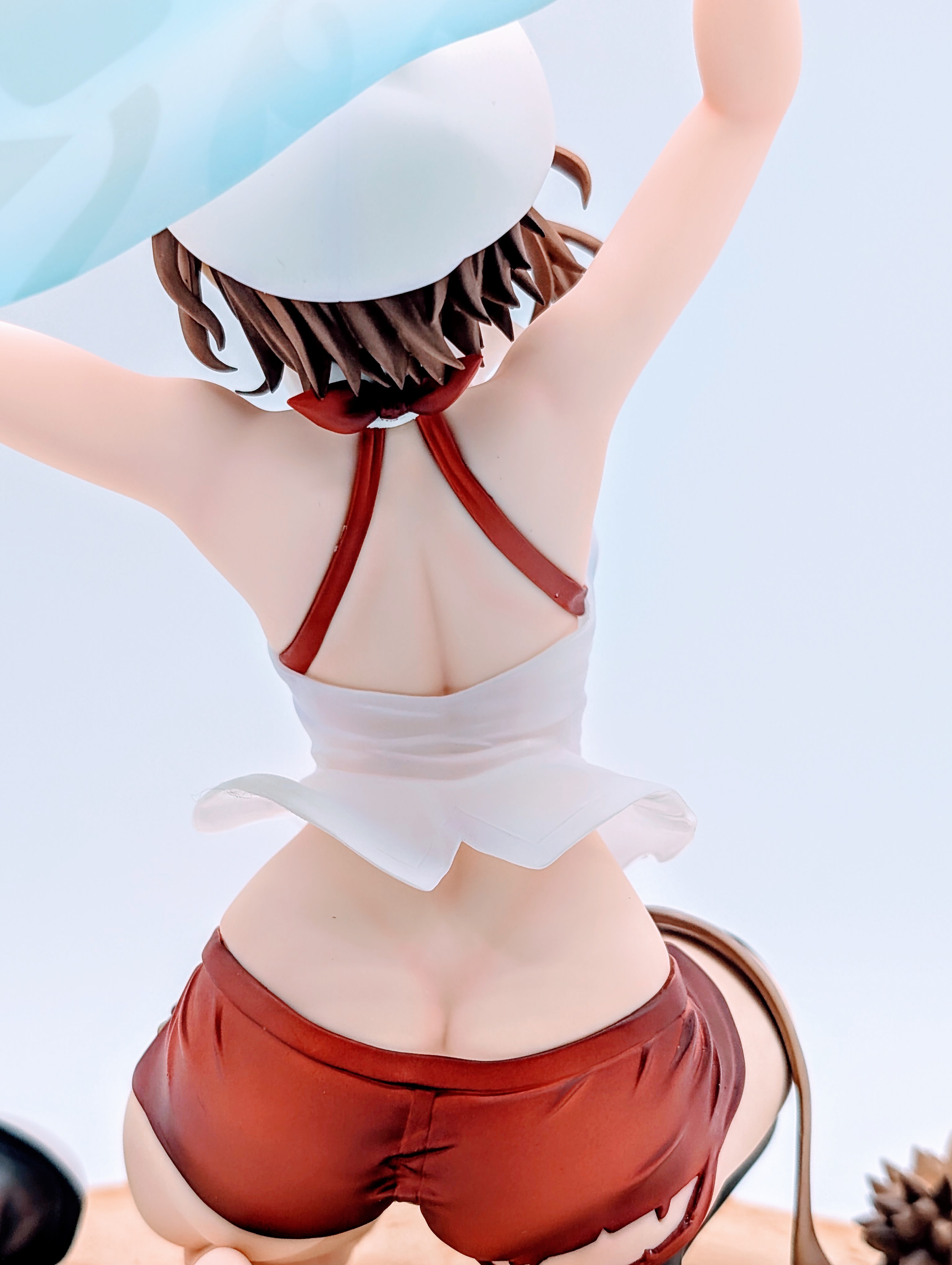 Back close-up of Ryza’s shoulders, bikini straps and shirt hem