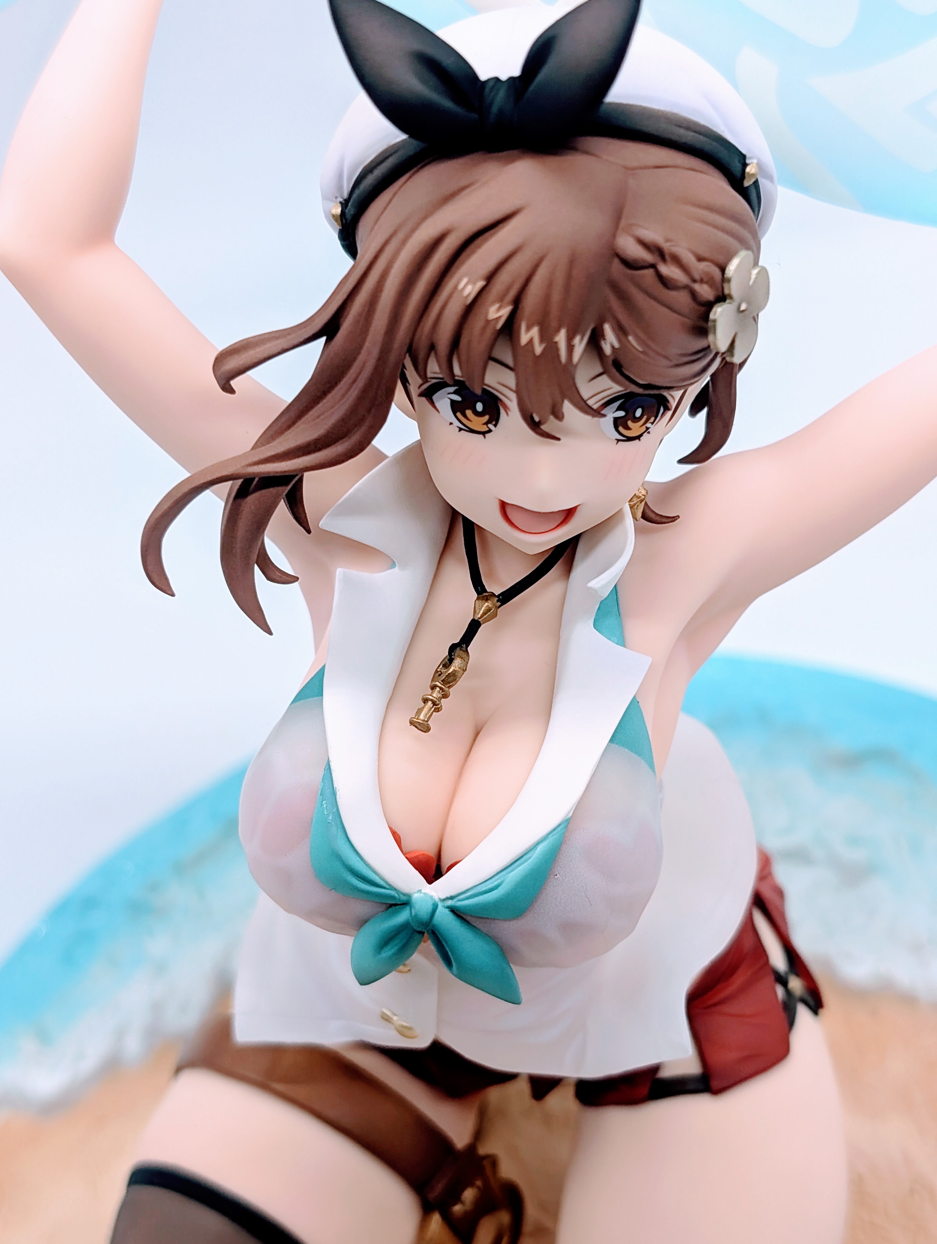 Front close-up of Ryza thighs and one stocking-covered leg on sandy base