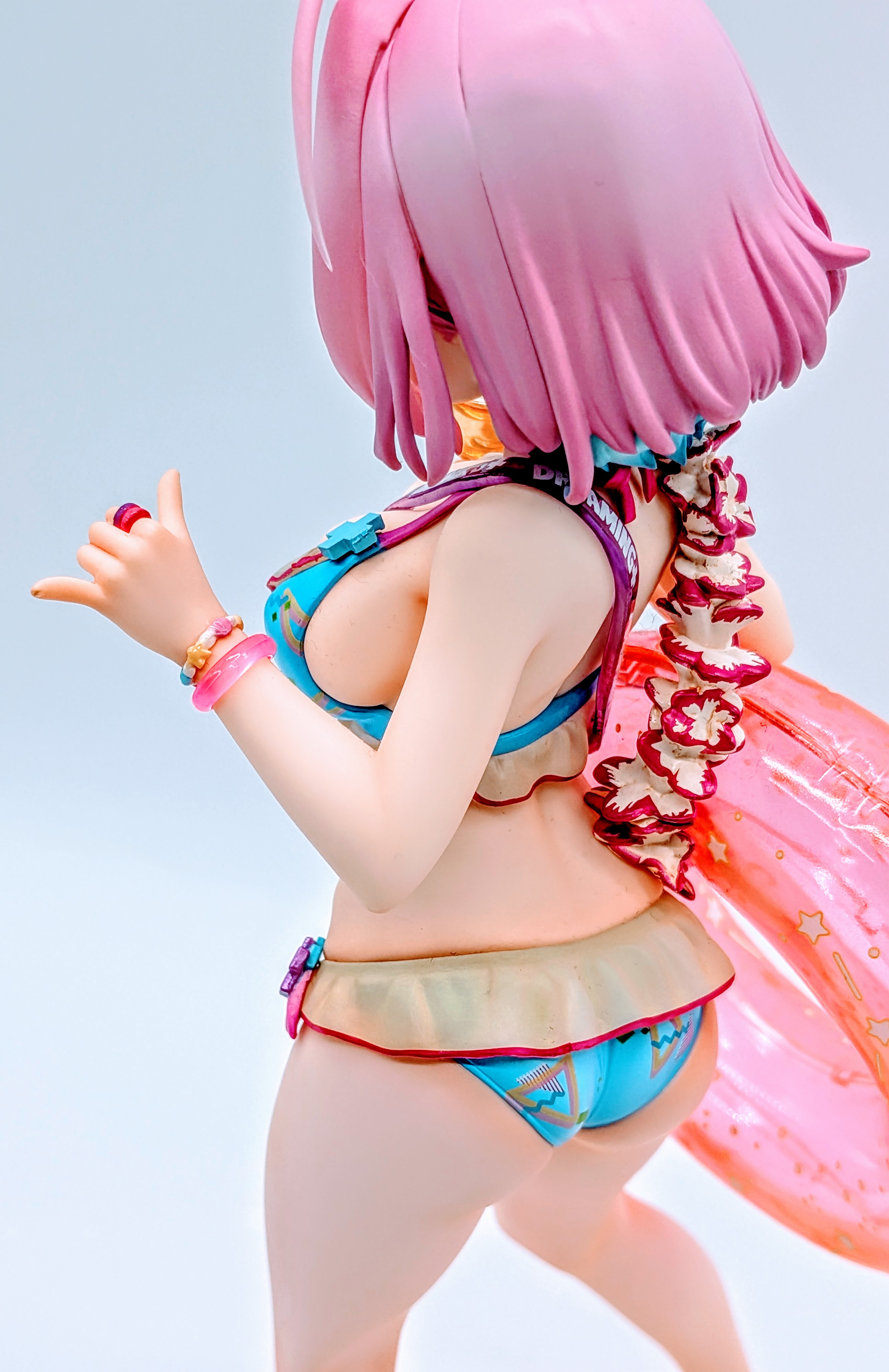 Back-side close-up of Yumemi Riamu swimsuit figure bust and hips