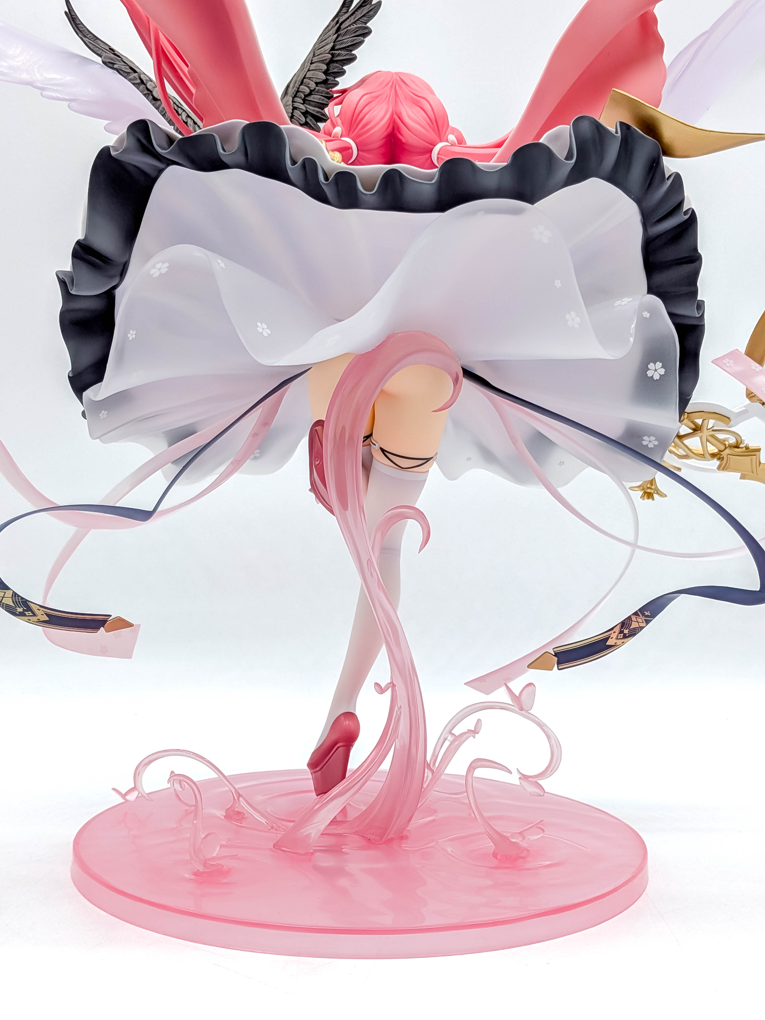 Perseus figure low rear view beneath the layered skirt