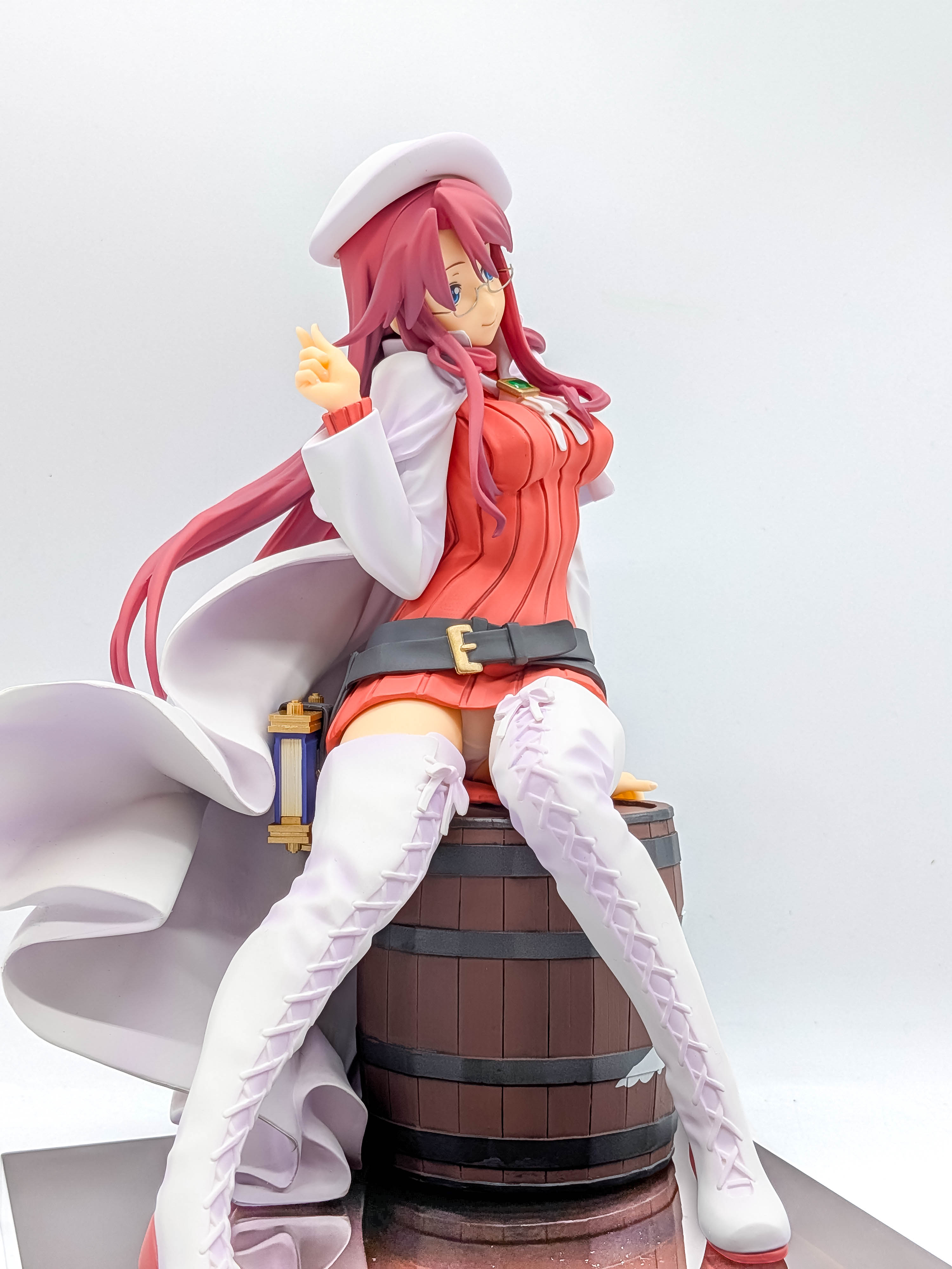 Aty figure angled full view seated on wooden barrel