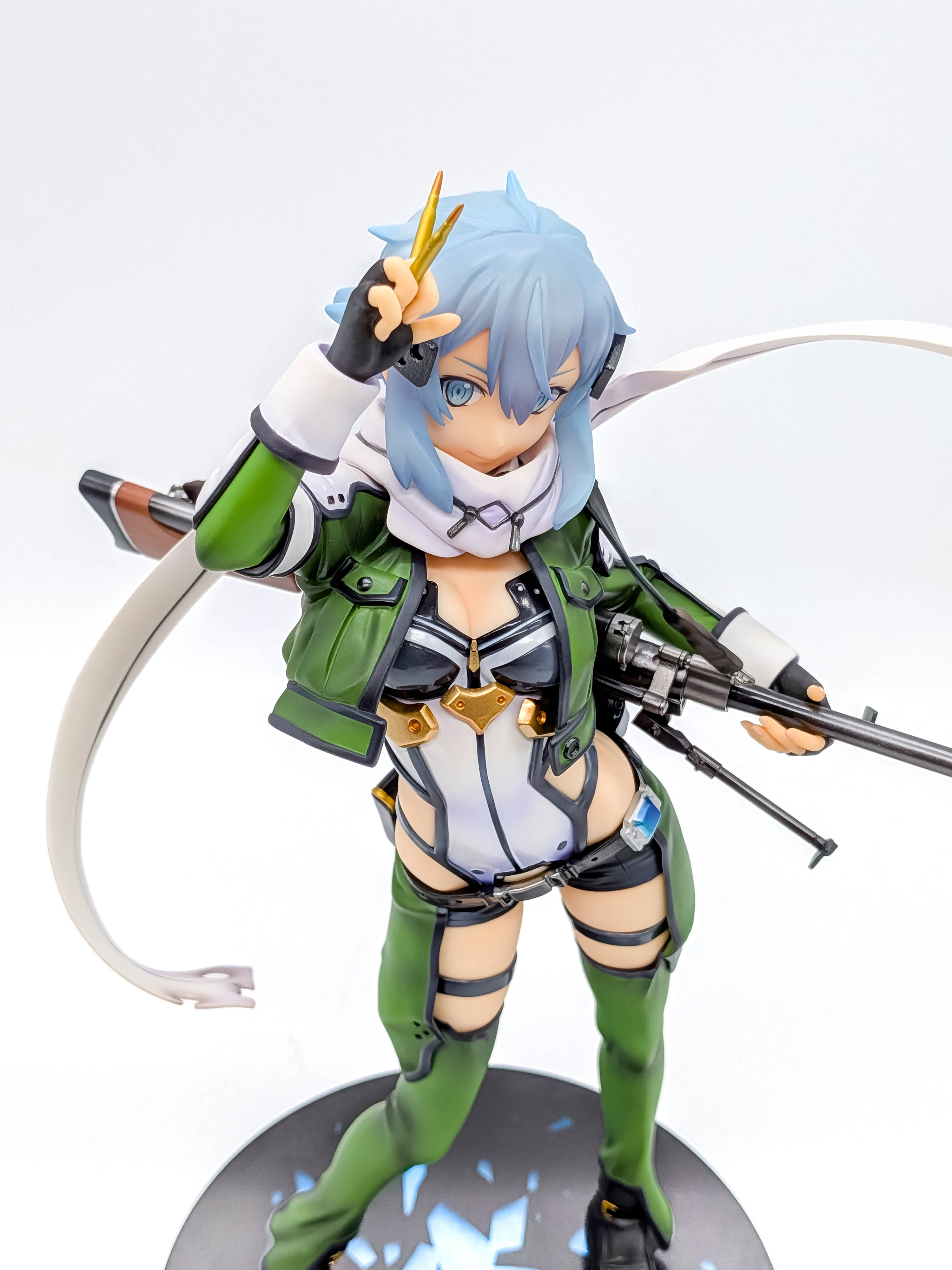 Sinon figure high-angle view with raised cartridges and flowing scarf