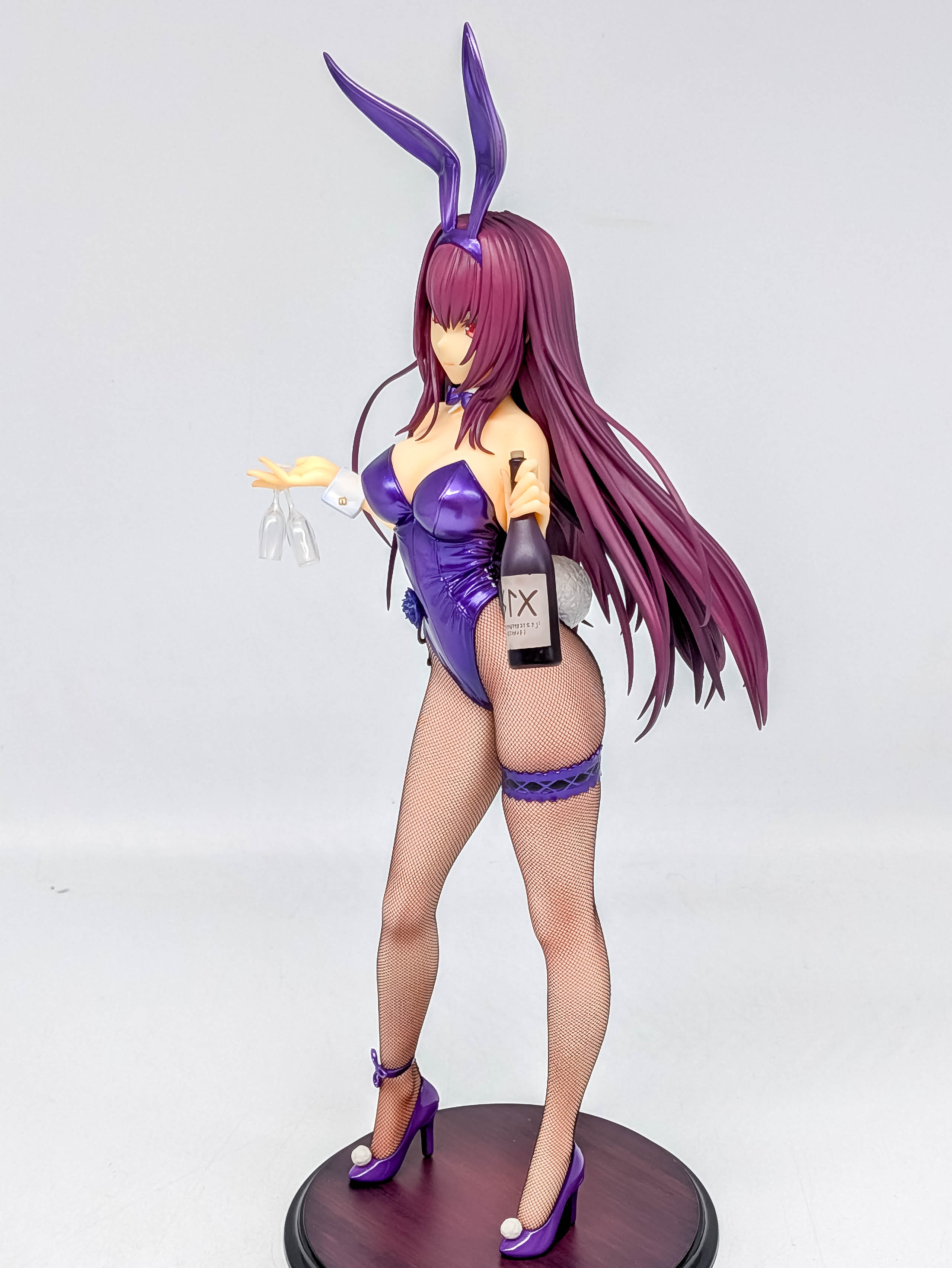 Opposite full side view with bottle, long legs and high heels