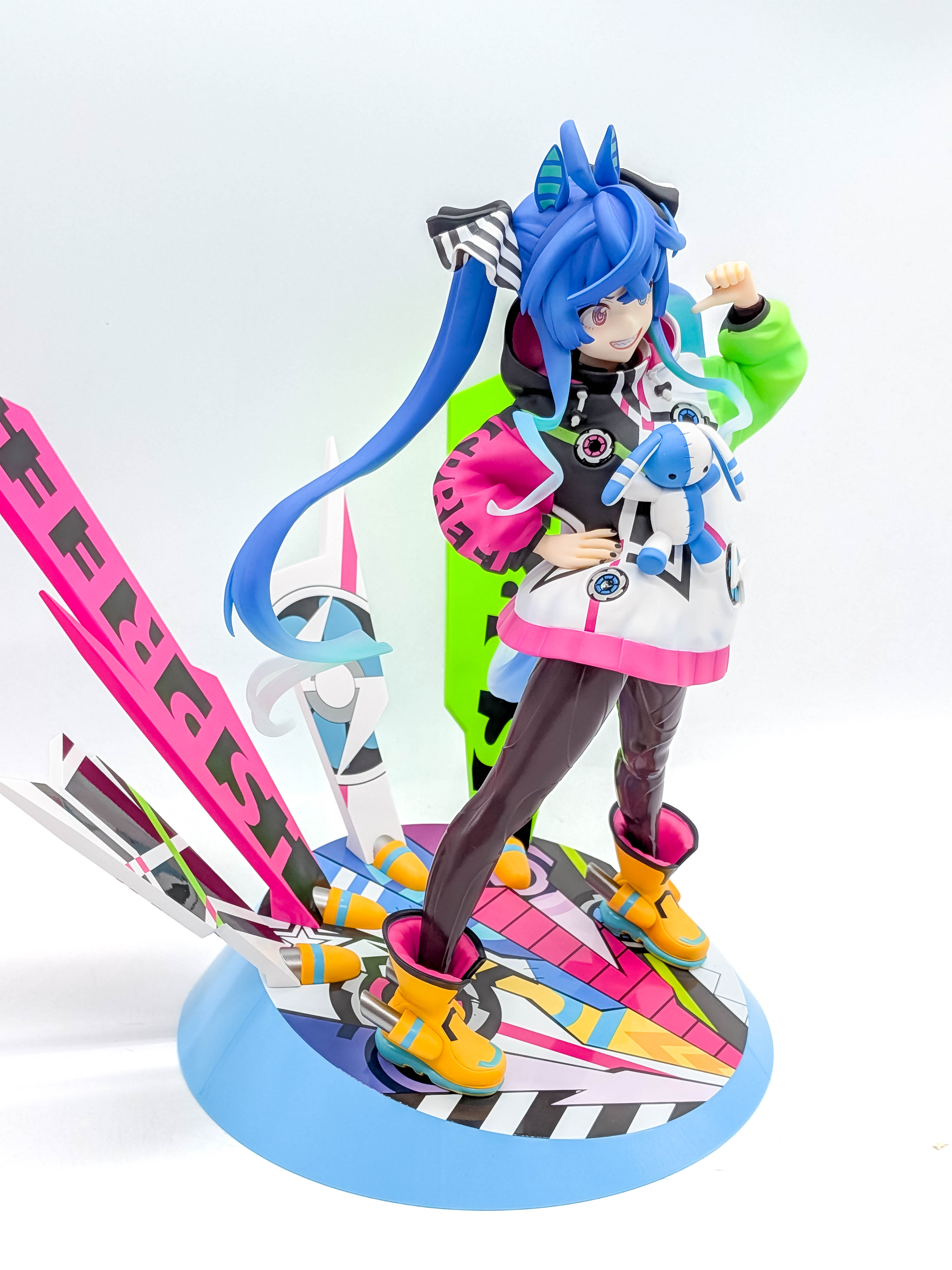 Twin Turbo figure three-quarter full view with colorful background panels